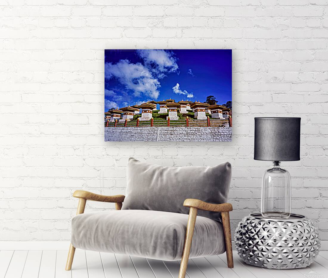 Traditional Bhutanese chortens on a green hill blue sky. Reproduction