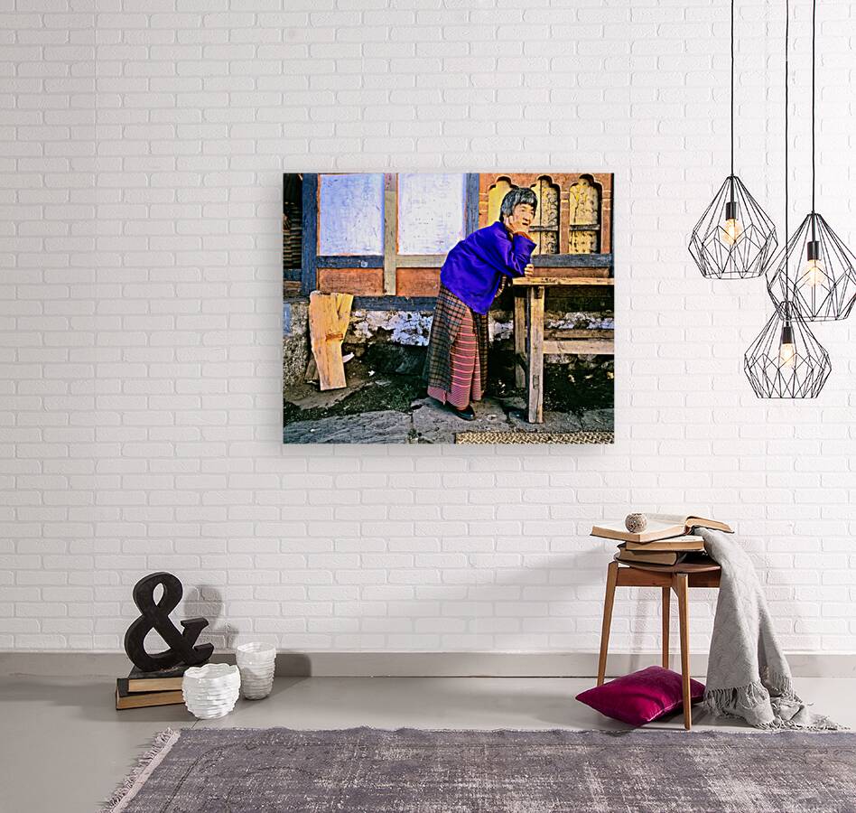 Smiling elderly woman in traditional dress leaning on wooden tab Reproduction