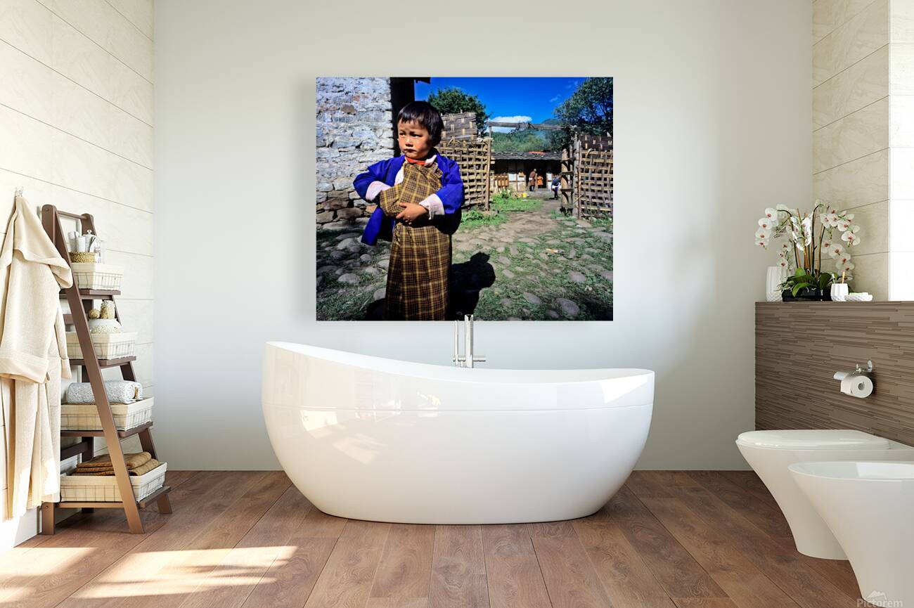 Young child in traditional Bhutanese dress in village. Reproduction