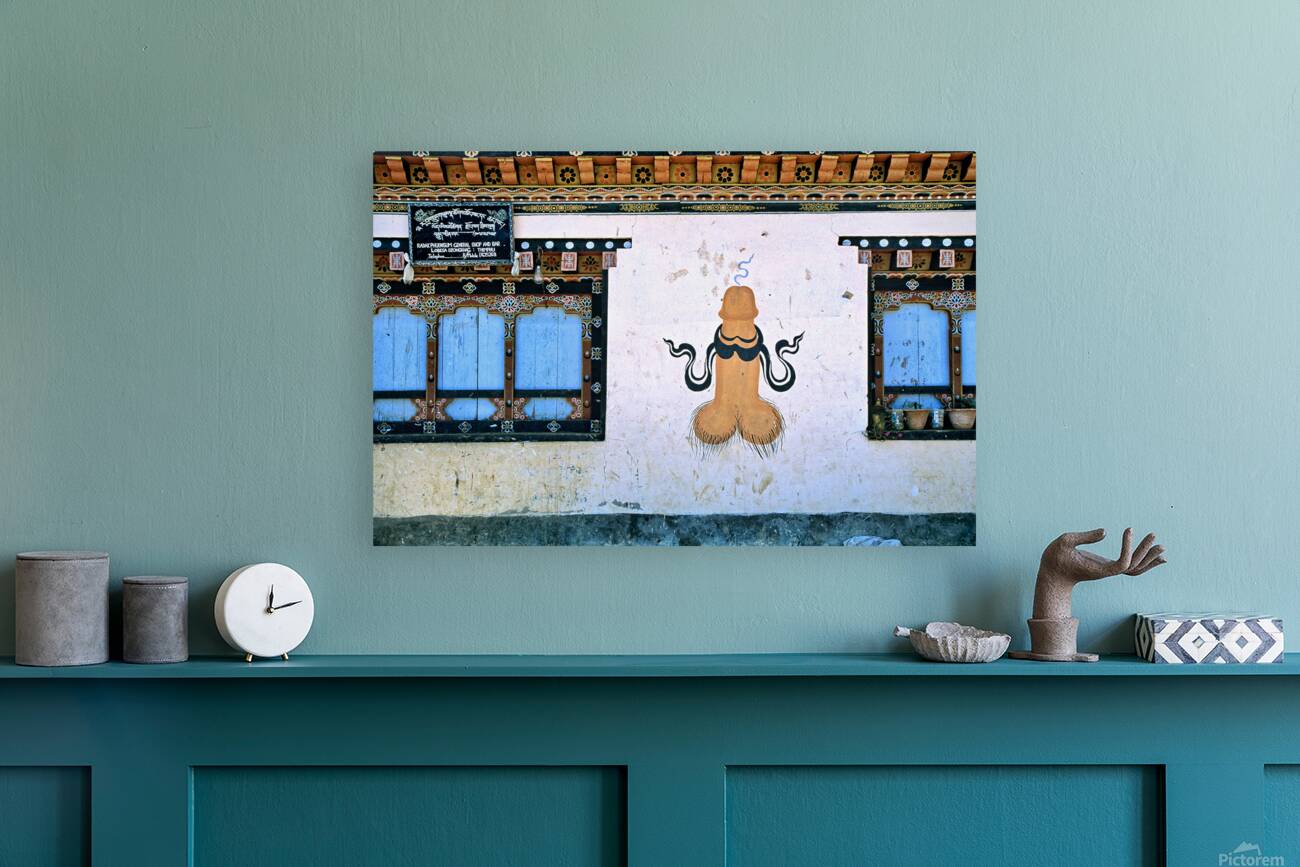 Phallus painting on a building wall with windows and shop sign. Reproduction