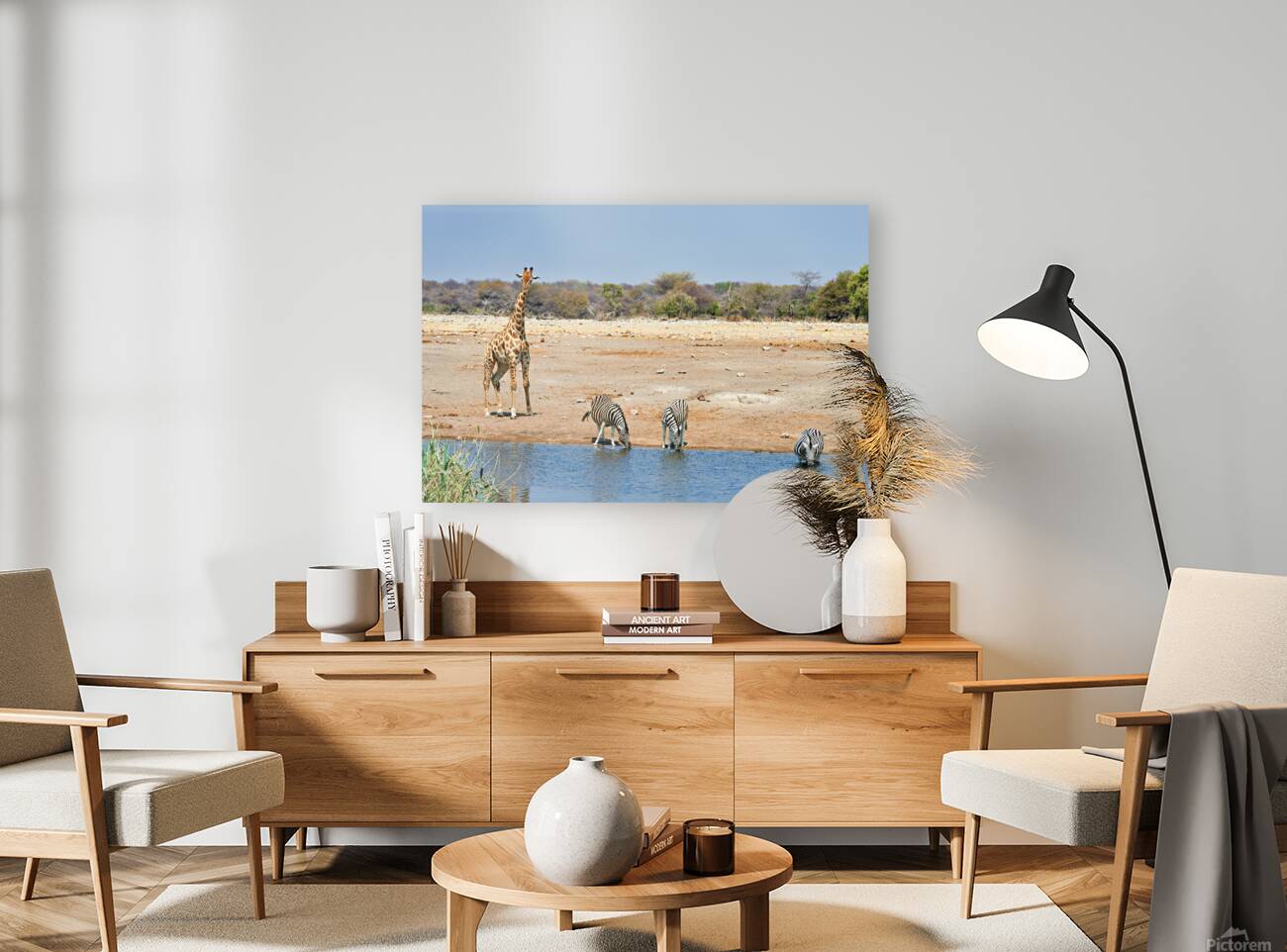 Giraffe and zebras drink water together at a waterhole in Namibi Reproduction