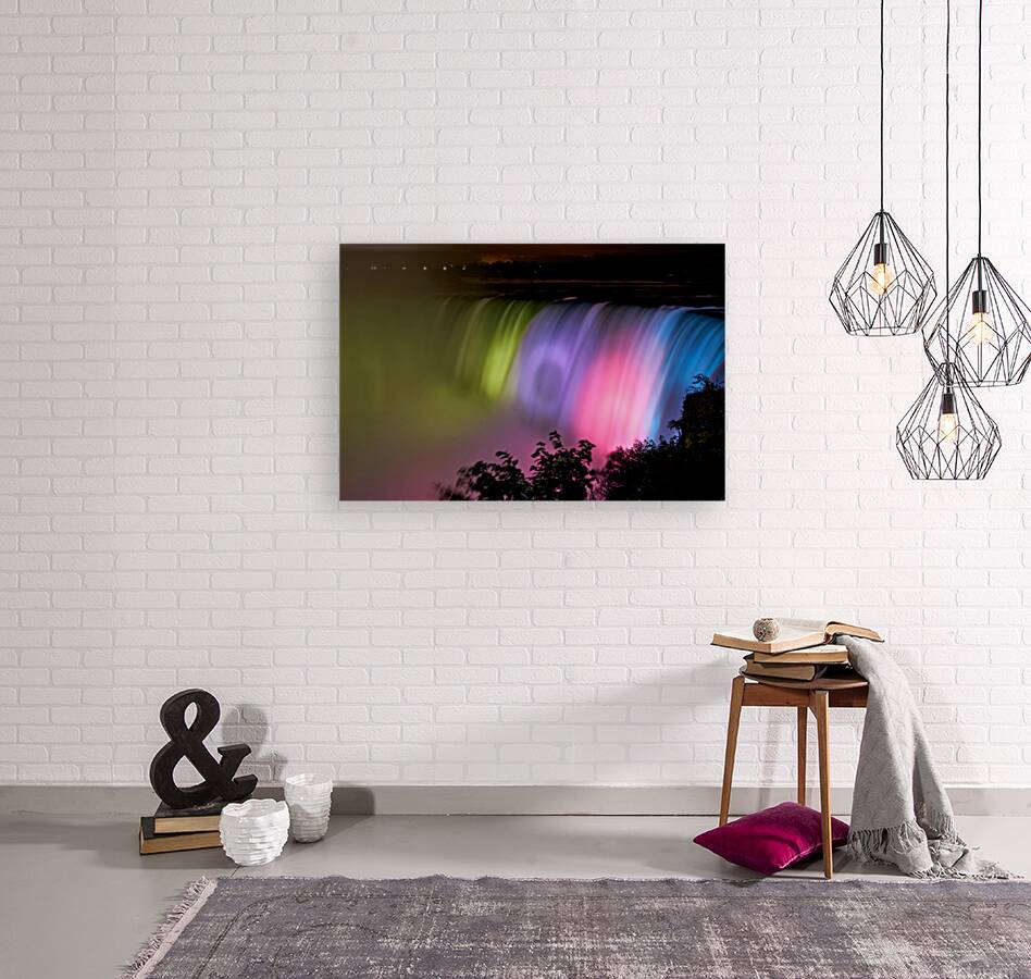 Niagara Falls illuminated with vibrant colors at night. Reproduction