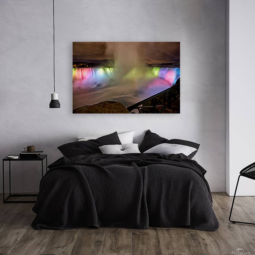 Niagara Falls illuminated at night with colorful lights. Reproduction