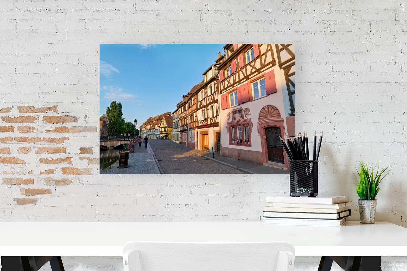 People walking along the canal in Petite Venise Colmar during ev Reproduction