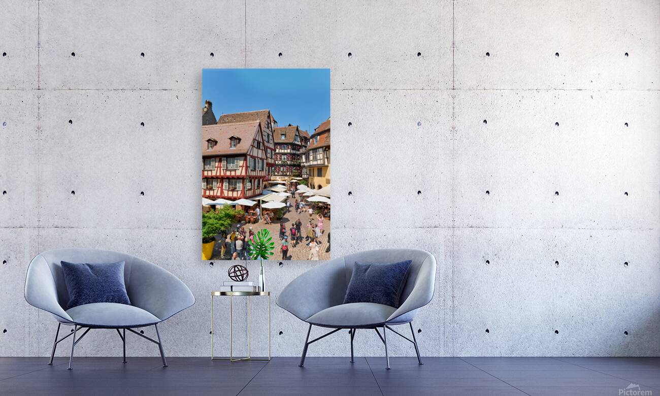 Visitors walk through Colmar on sunny day near timber framed hou Reproduction