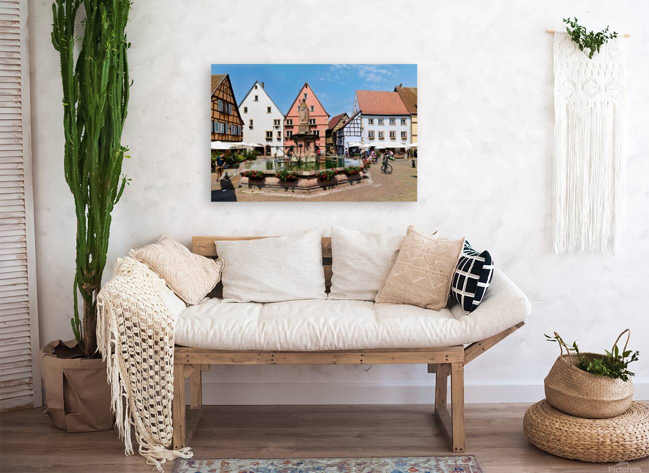 Visitors enjoy Saint Leon square in Eguisheim Alsace on a sunny Reproduction