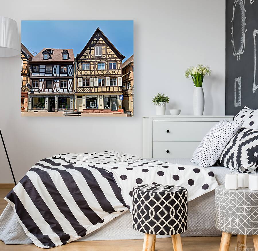 Visitors explore timber framed houses in Colmar Alsace on a sun Reproduction