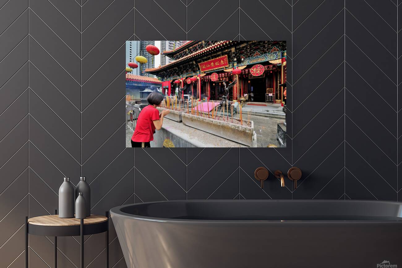 Woman prays with incense at colorful Chinese temple in Hong Kong Reproduction