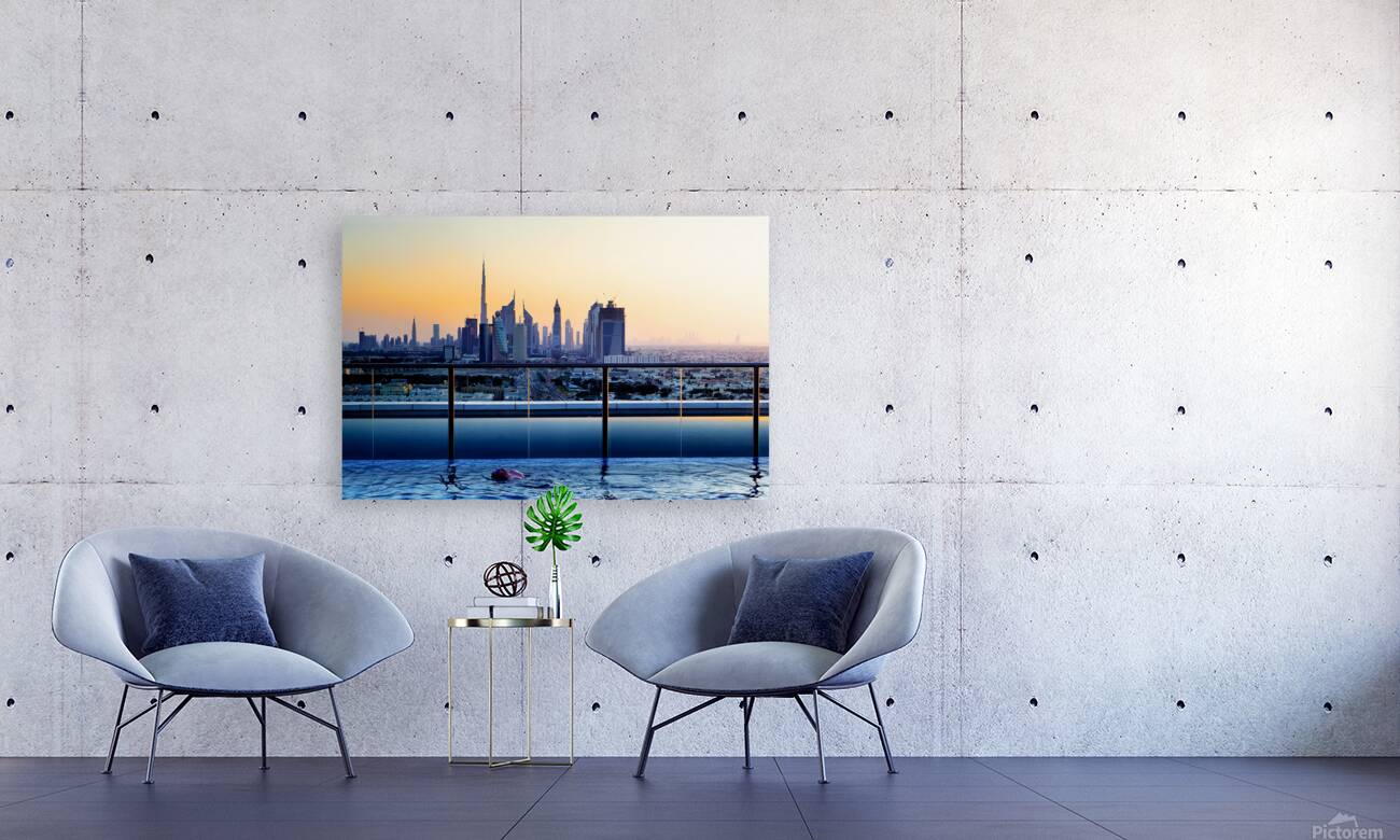 Swimming in infinity pool overlooking Dubai skyline at sunset Reproduction