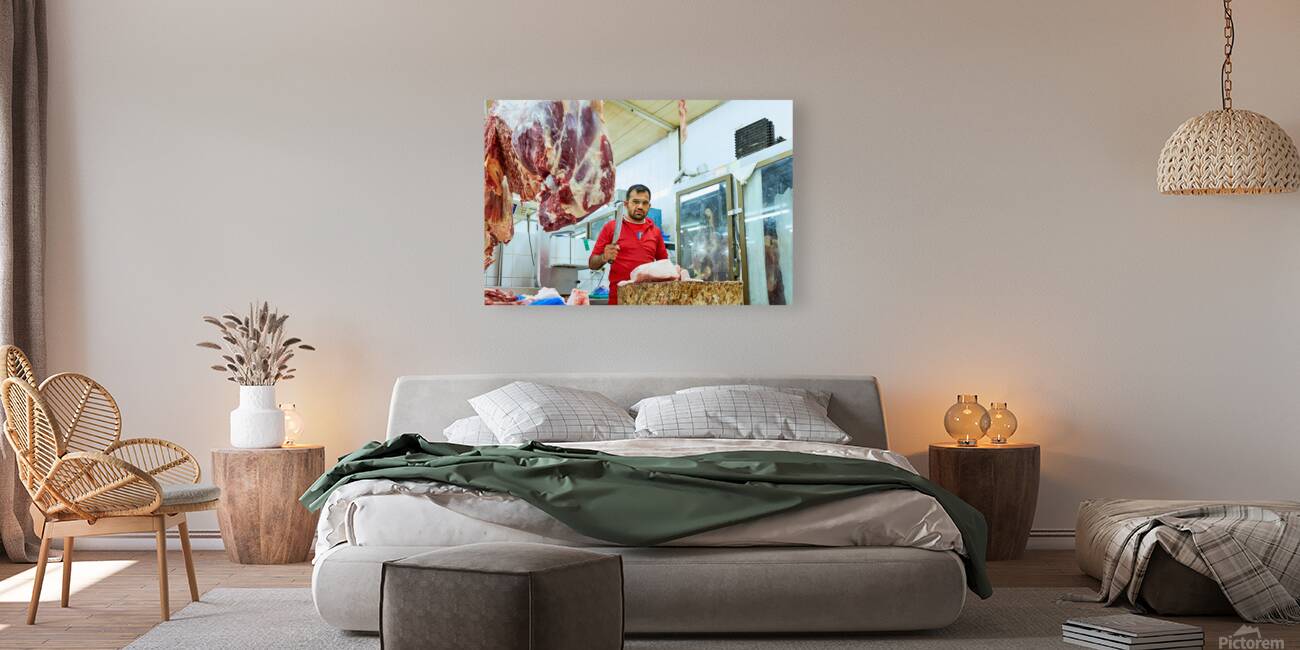 Butcher works with meat in a shop in Dubai UAE Reproduction