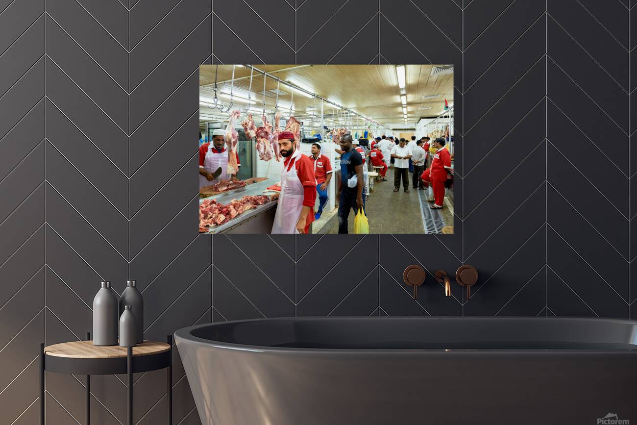 Butchers work at a busy meat market in Dubai UAE preparing fresh Reproduction