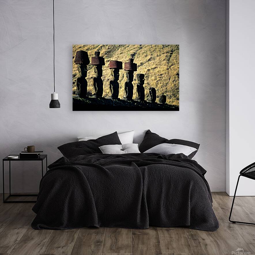 Easter Island Moai statues with red hats on a hillside. Reproduction