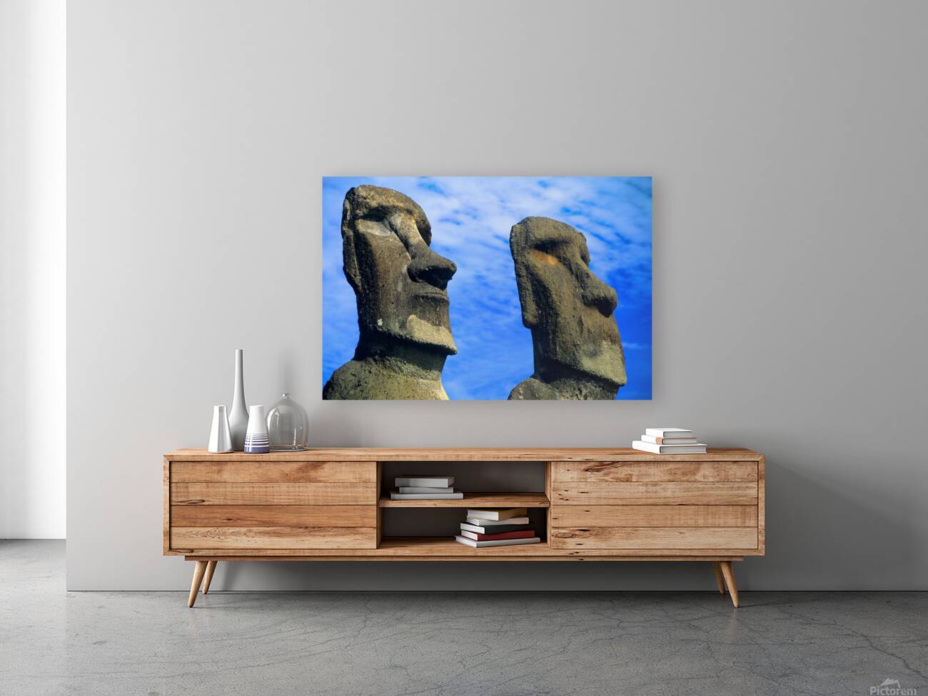 Two Moai statues against a blue sky. Reproduction