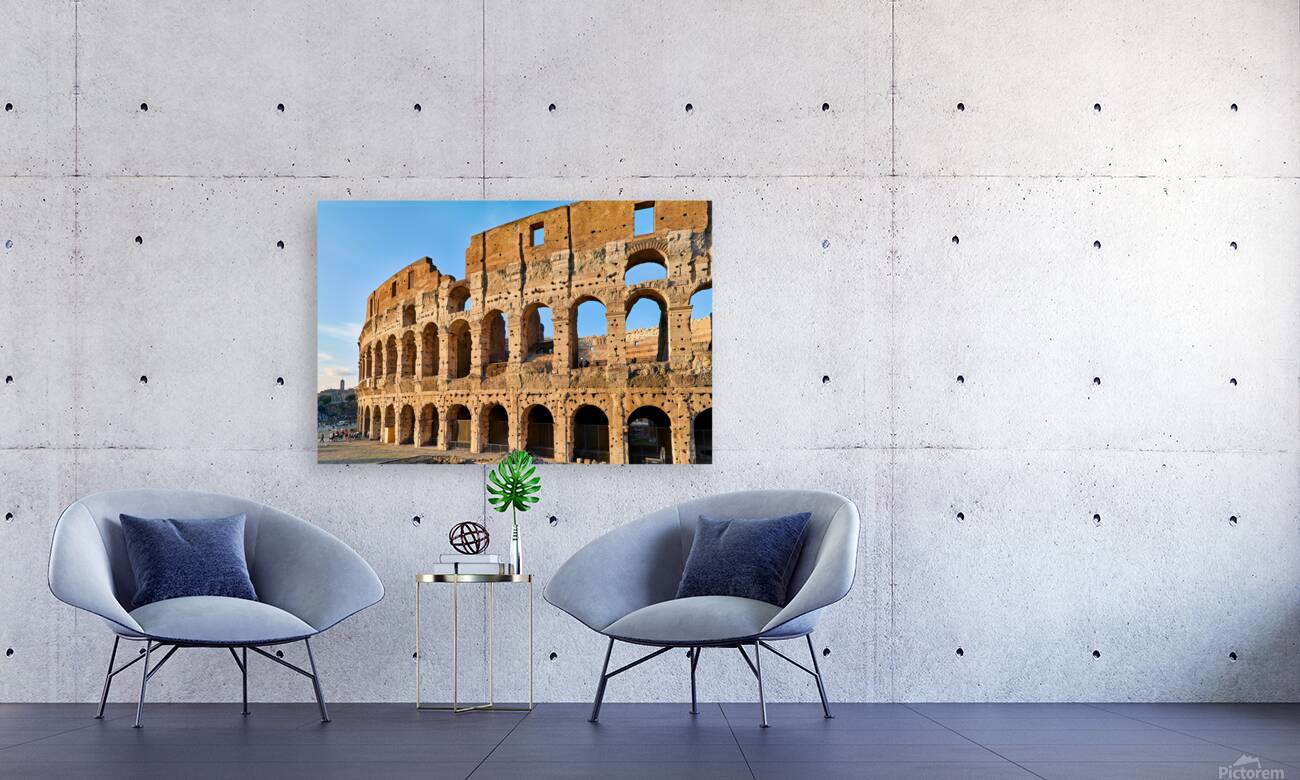 Colosseum stands tall in Rome during golden hour Reproduction