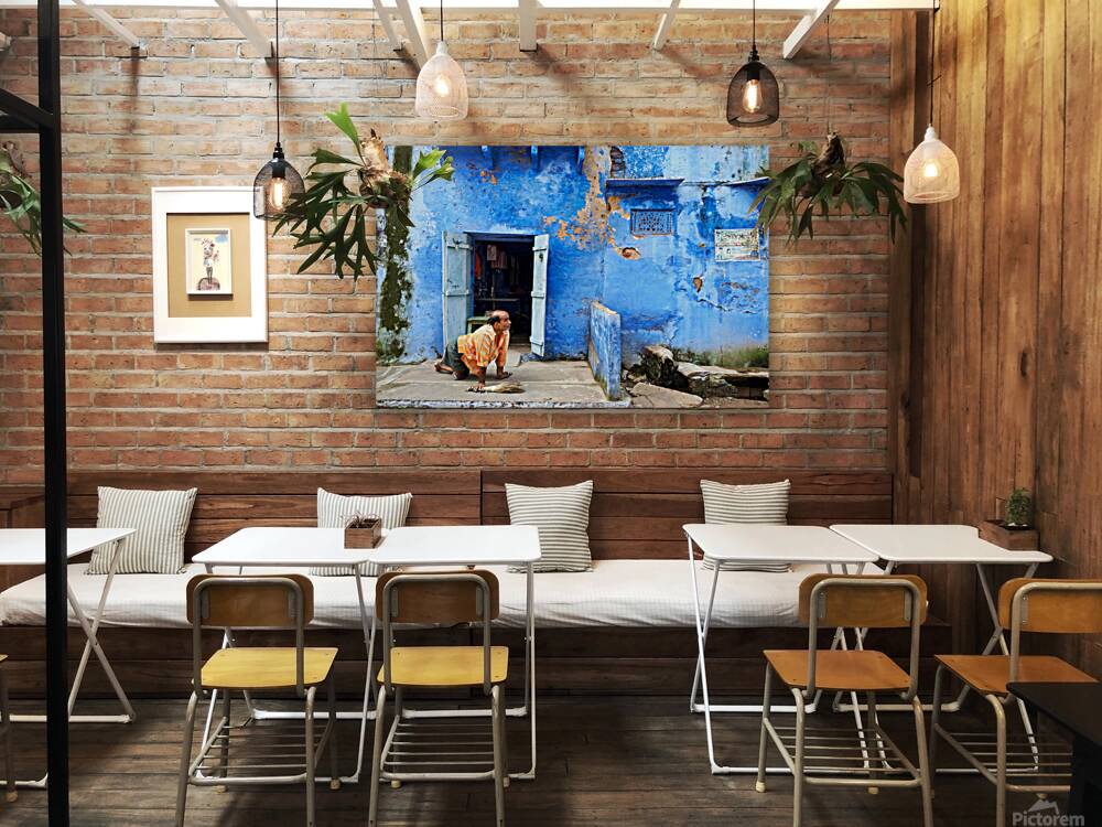 Man sweeps in front of home in Bundi Rajasthan during the day Reproduction