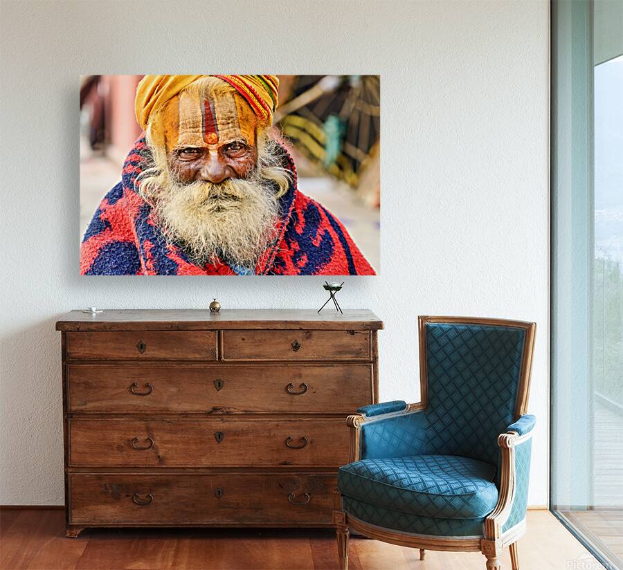 Old holy man in Varanasi wearing bright colors in Uttar Pradesh Reproduction