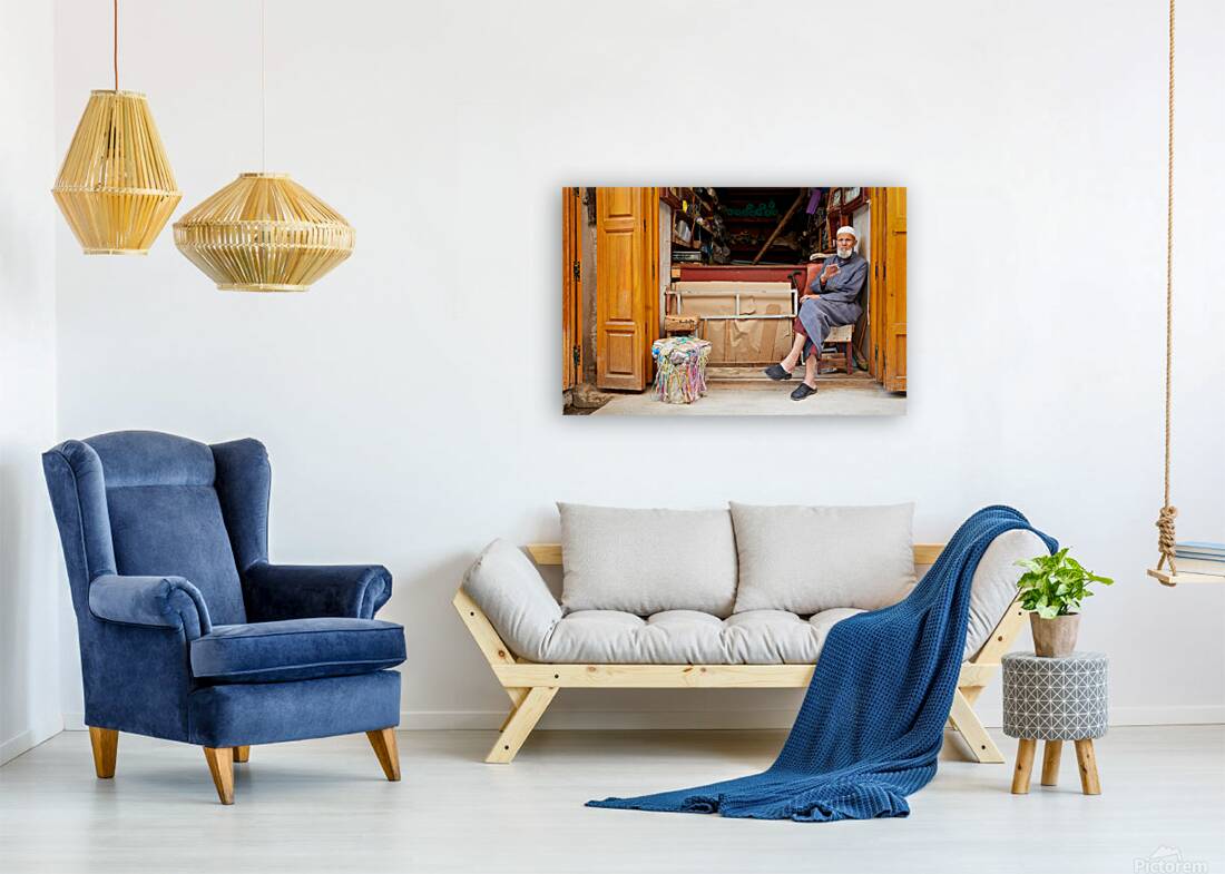Old man in second hand shop at medina in Fez Morocco Reproduction