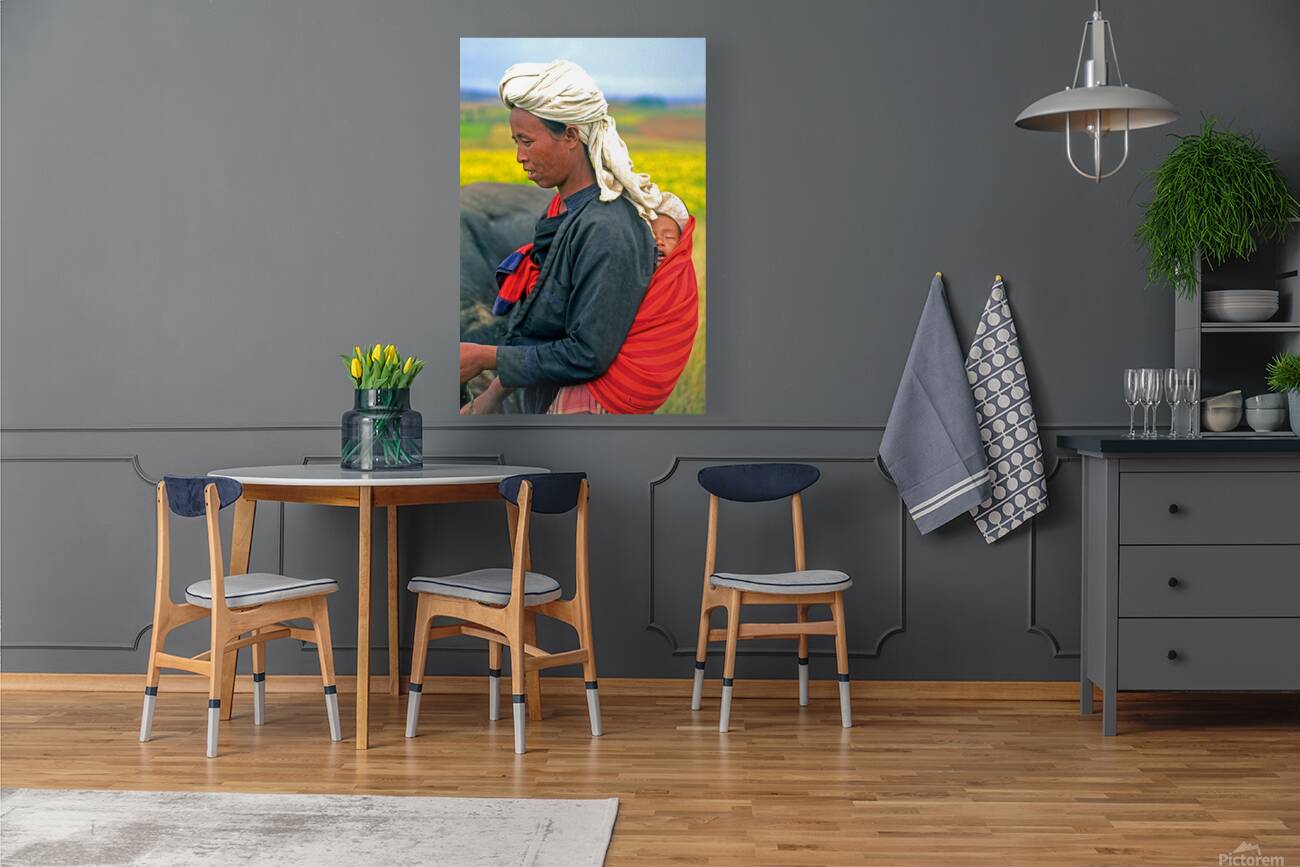 Woman carries son on her back in Myanmar fields Reproduction