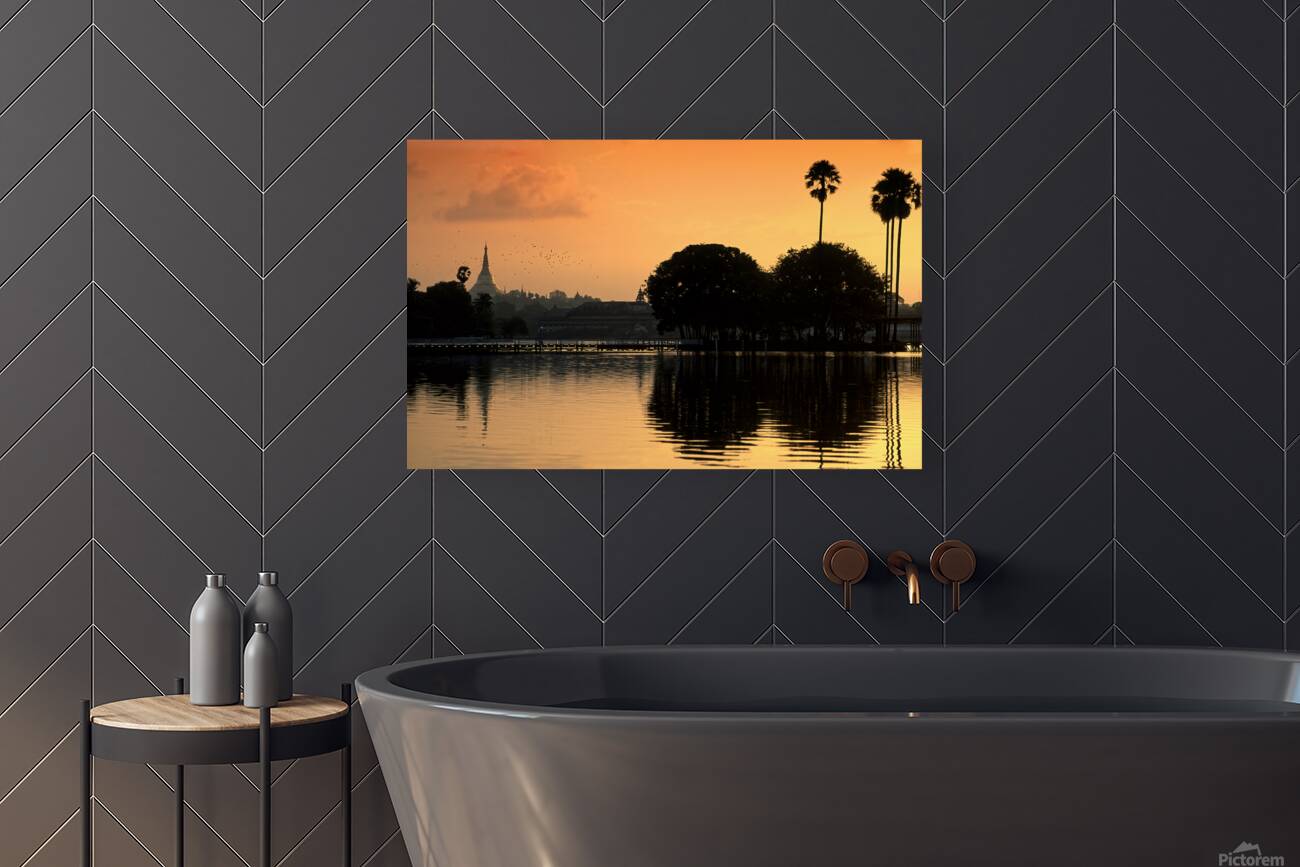 Sunset over the water in Yangon with palm trees and buildings Reproduction