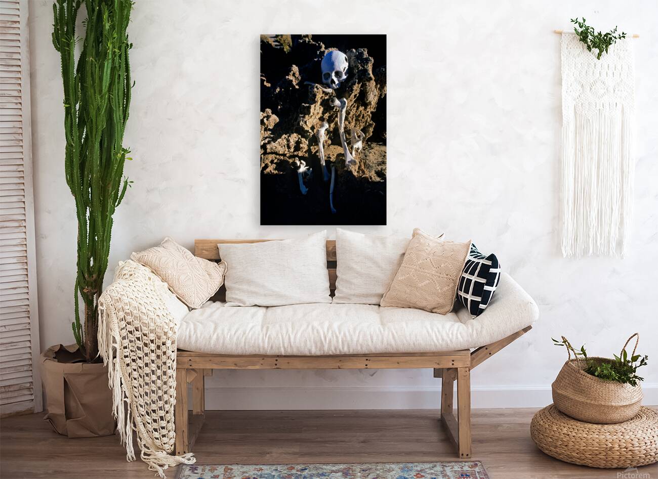 Human skeleton partially buried in rocky terrain. Reproduction