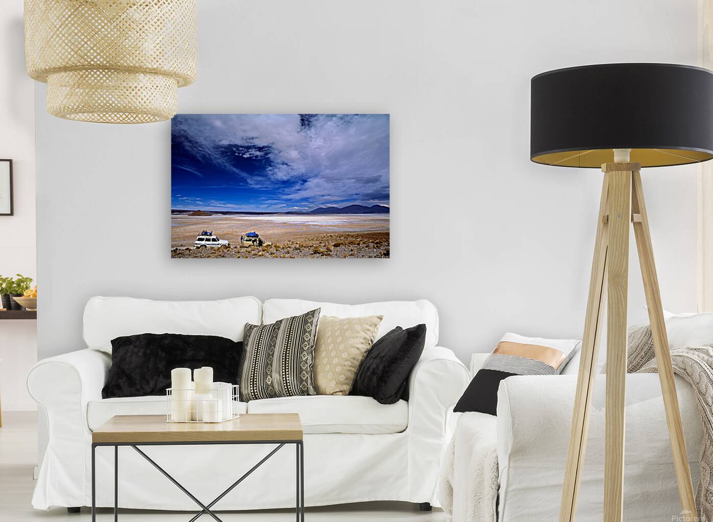 Vehicles traverse a vast arid salt flat landscape. Reproduction