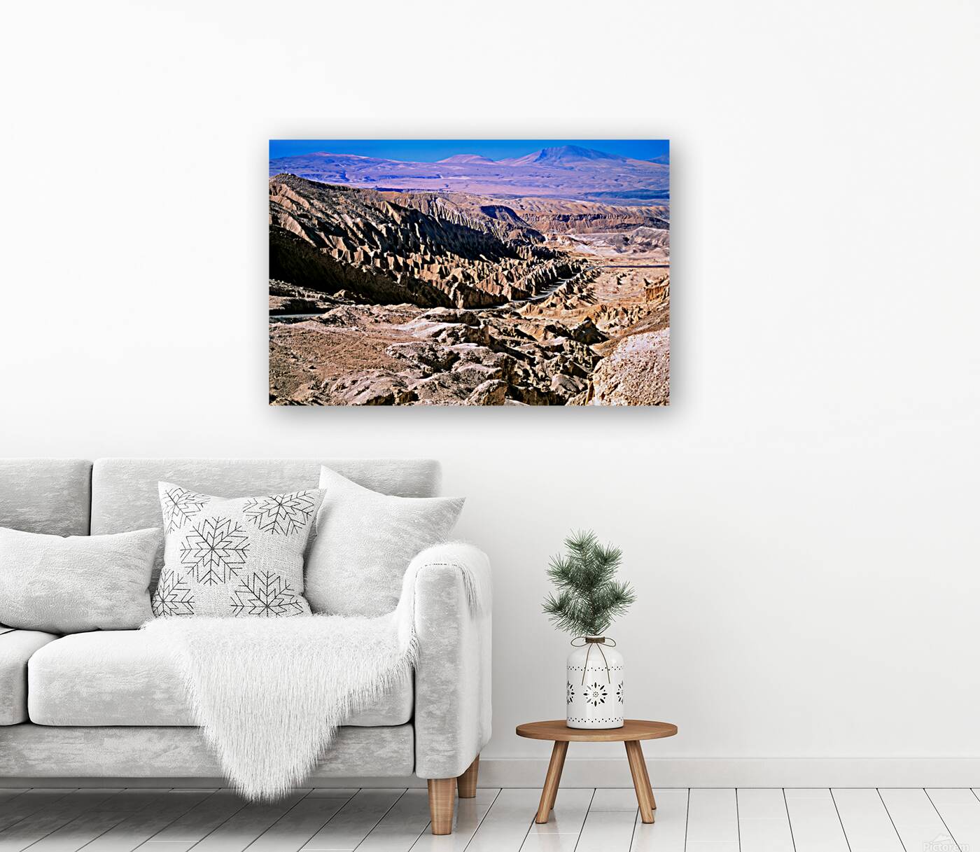 Eroded desert landscape with a road winding through mountains. Reproduction