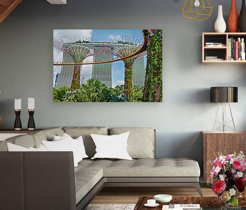 People walk on bridge connecting to Supertree Grove in Singapore Reproduction