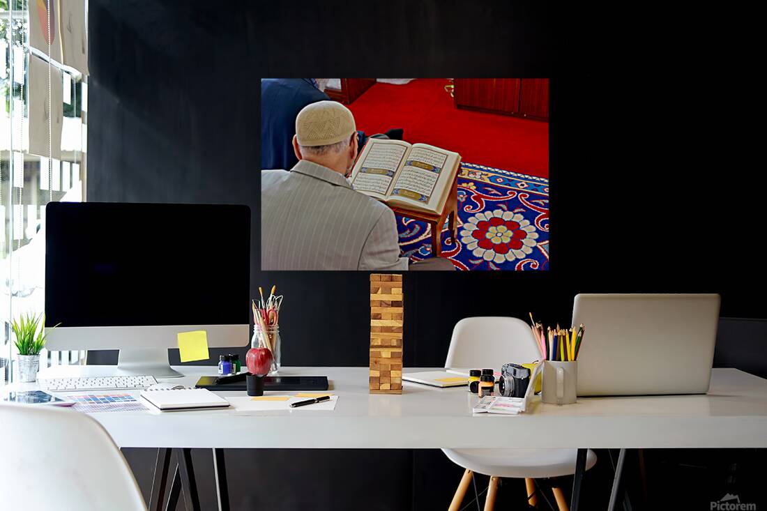Man reading Quran inside Fatih Mosque in Istanbul Turkey Reproduction