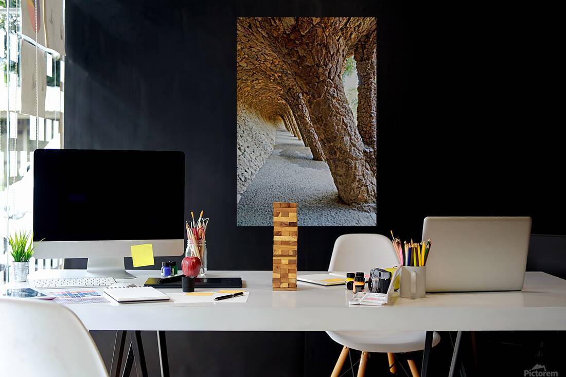 Walking through the colonnaded pathway in Park Guell Barcelona Reproduction