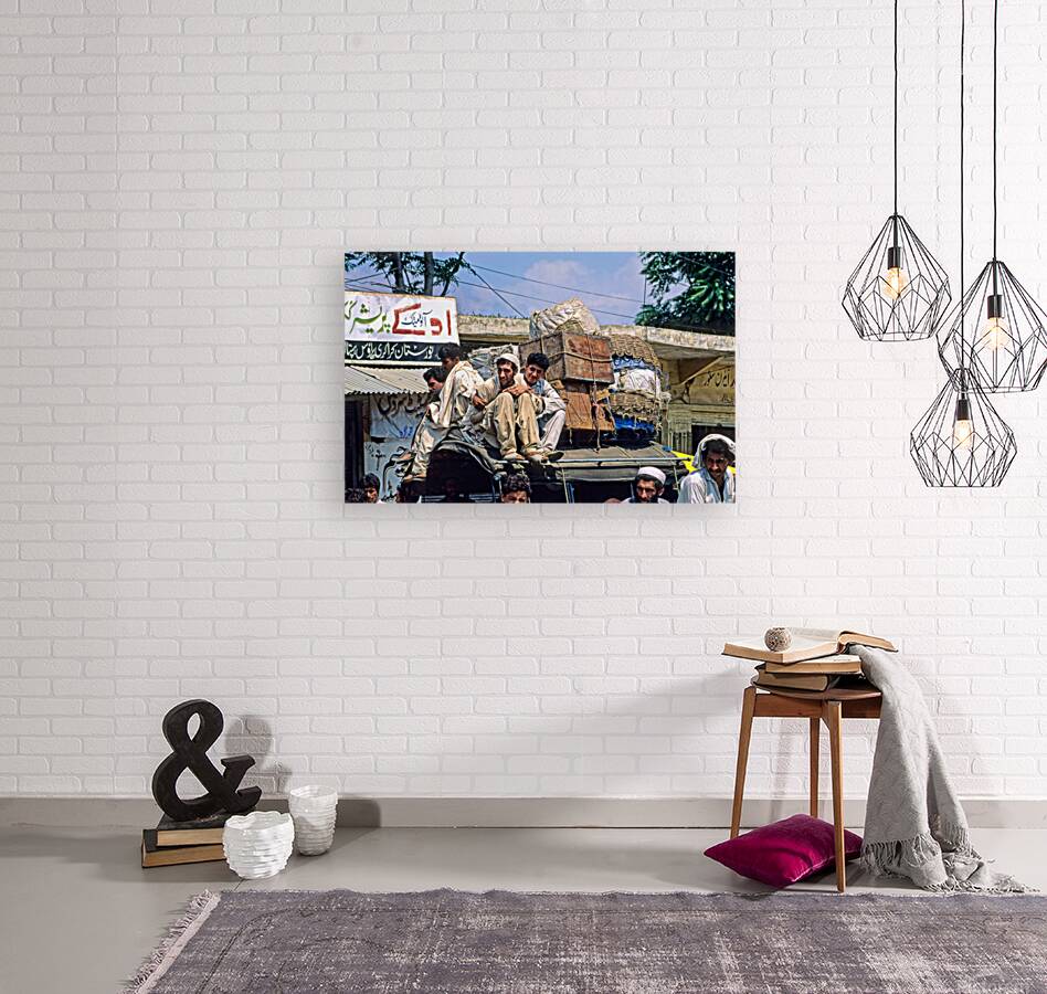 Men travel on top of a vehicle in Peshawar Pakistan Reproduction