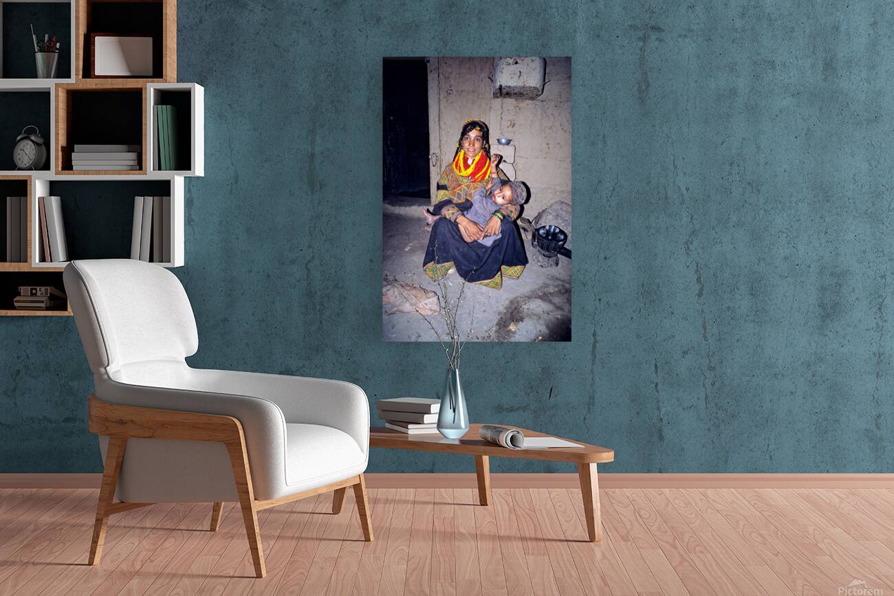 A woman holds her child in a Kalash village Reproduction