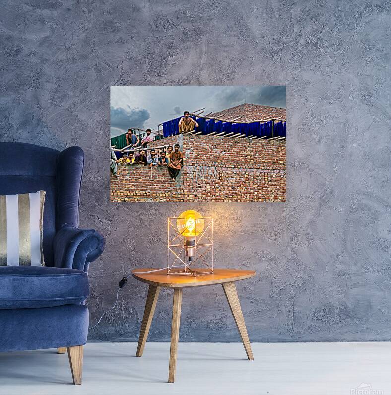 Workers rest during break time at a construction site in Lahore Reproduction