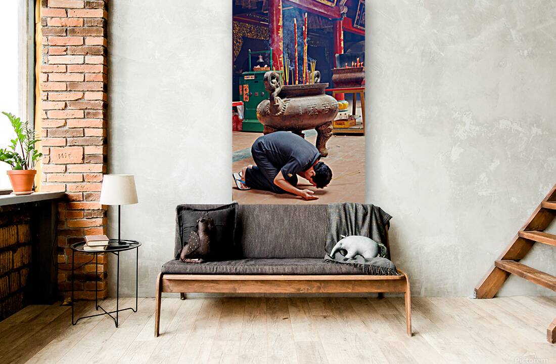 Man praying at a shrine in Ho Chi Minh City Vietnam Reproduction