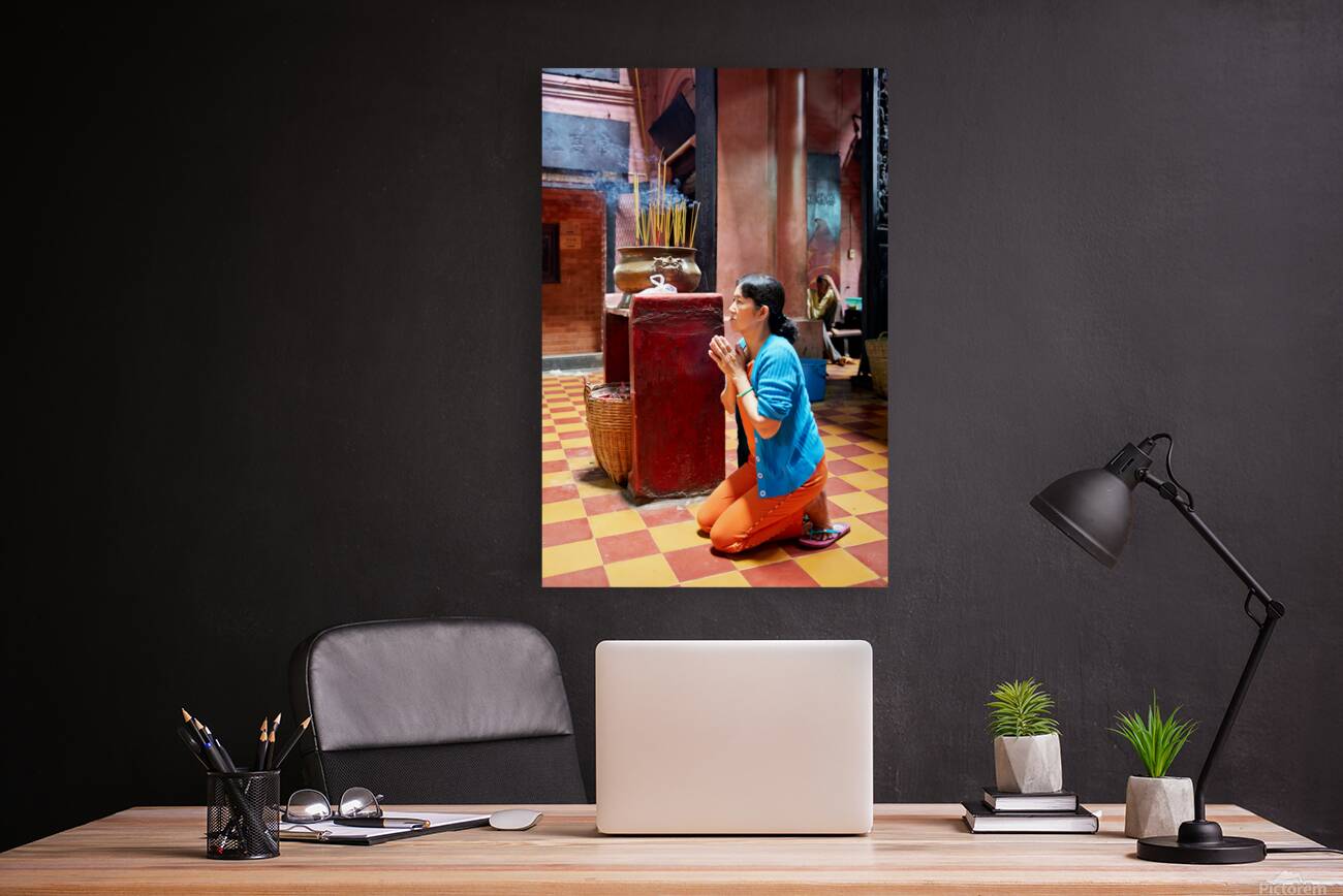 Woman prays at a temple in Ho Chi Minh City Vietnam Reproduction