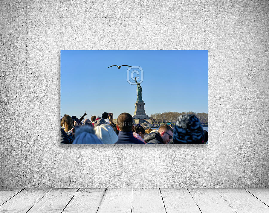 New York. Manhattan. United States. Tourists approaching Liberty Island by ferry Wall Preview