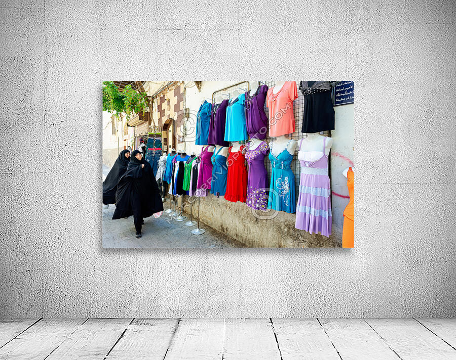 Syria. Damascus. Veiled women looking at western dresses Wall Preview