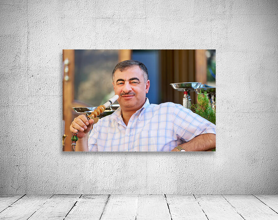 Syria. Aleppo. Man smoking hookah Wall Preview