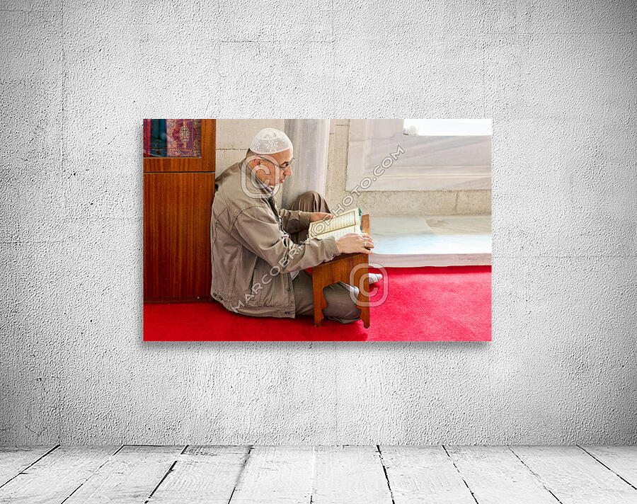 Istanbul Turkey. Muslim believer praying and reading Koran in the Fatih Mosque Wall Preview