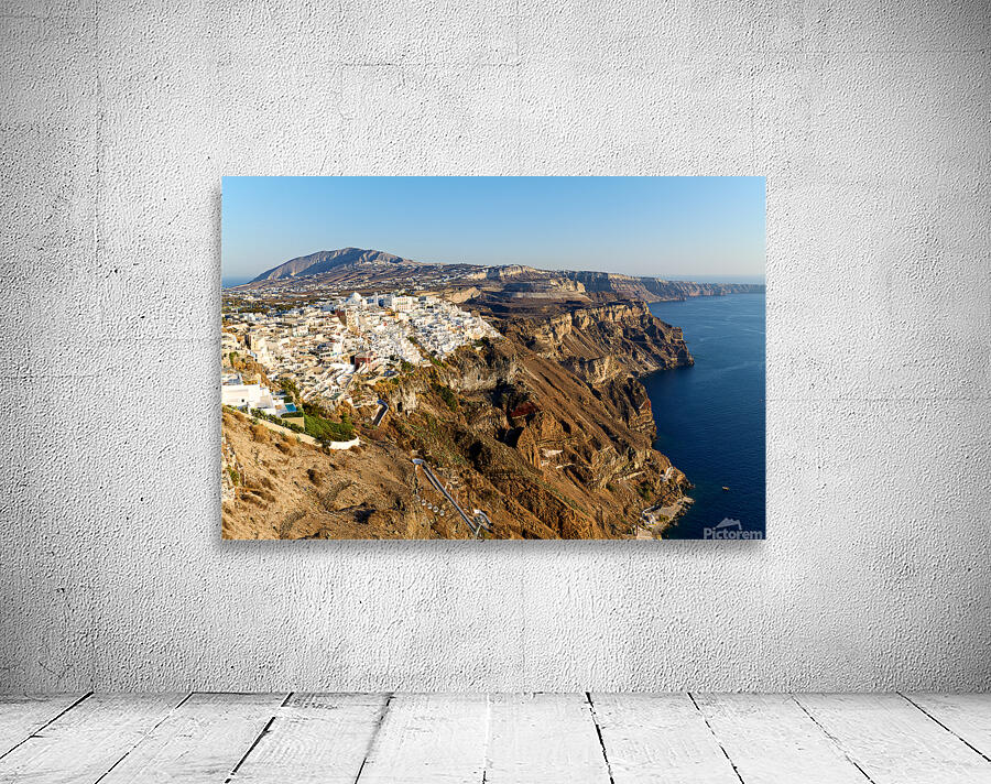Santorinis white buildings on caldera cliffs above the sea. Wall Preview