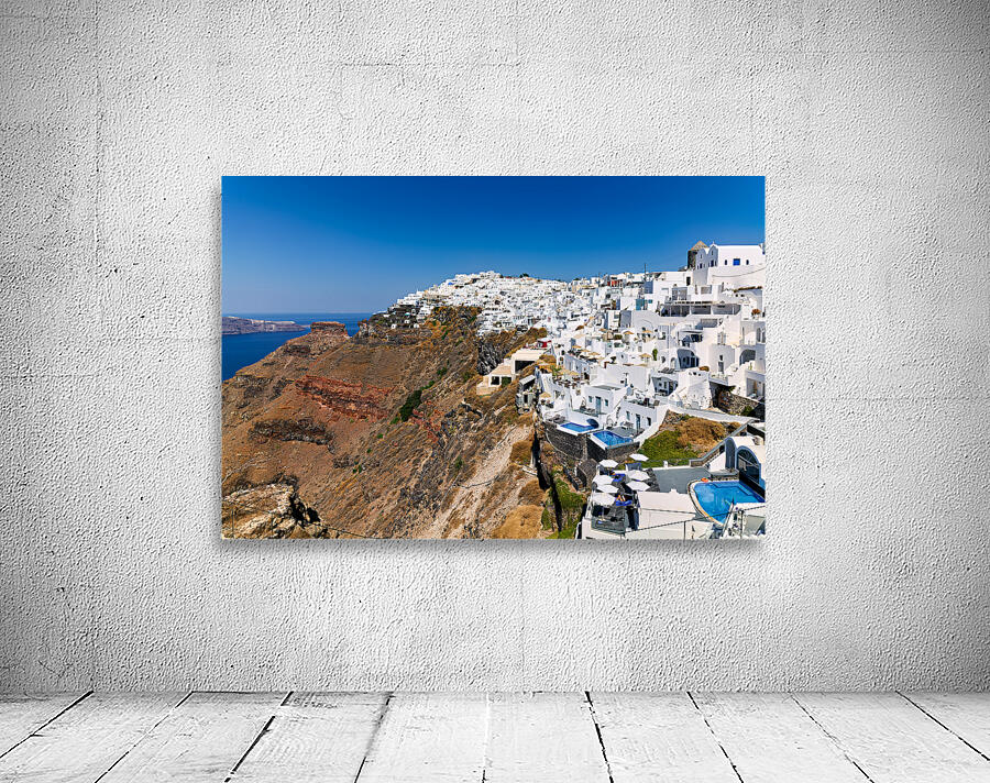 Santorini: White cliffside village blue sea clear sky. Wall Preview
