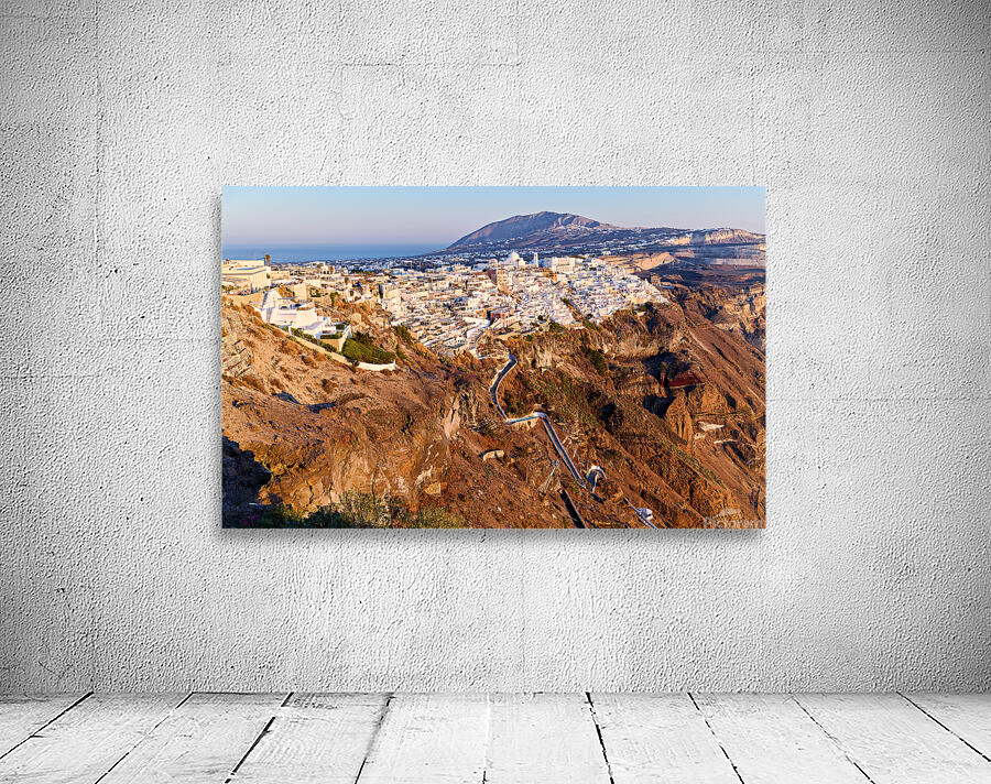 Santorinis Fira town on caldera cliff at sunset. Wall Preview