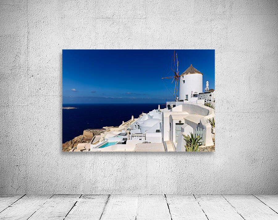 Santorinis iconic white architecture and windmill against the d Wall Preview