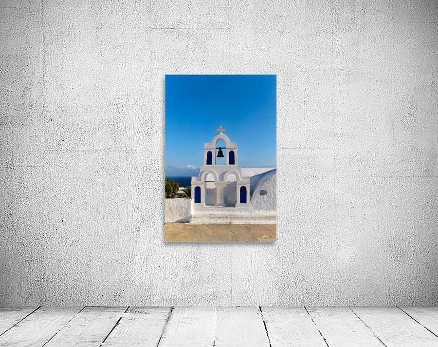 White bell tower against blue sky and sea. Wall Preview