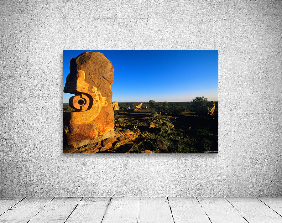 Sandstone sculptures glow at sunset in the Australian outback. Wall Preview