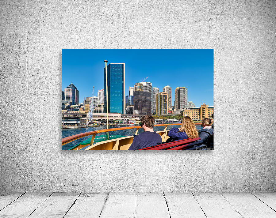 Ferry passengers enjoy city skyline view. Wall Preview