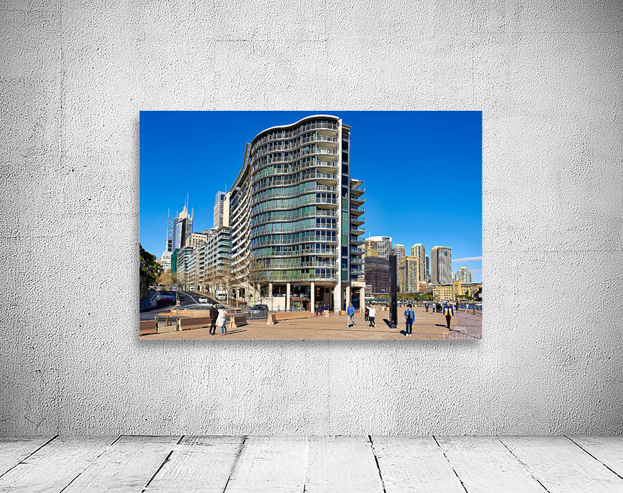 Modern curved building with balconies and city skyline. Wall Preview