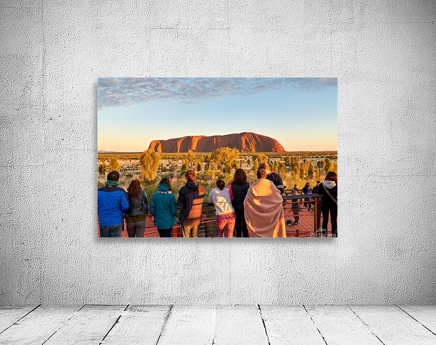 Tourists watch Uluru glow at sunrise. Wall Preview