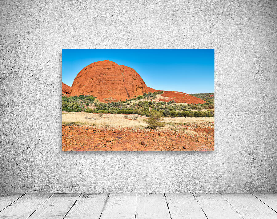 Vast red rock formation under a clear blue sky. Wall Preview