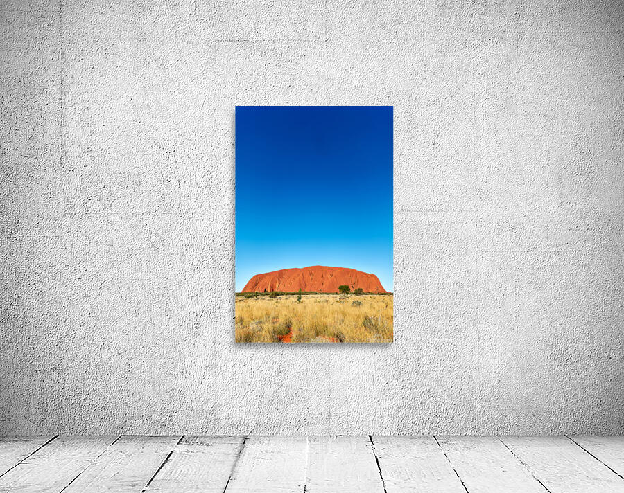 Uluru monolith under a clear blue sky. Wall Preview