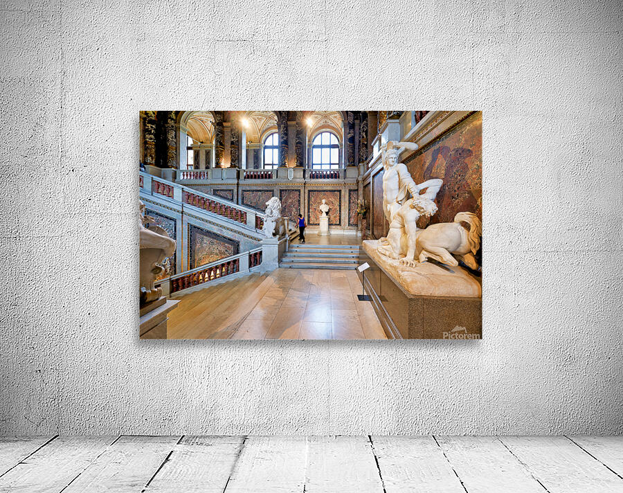 Ornate museum hall with statues grand staircase and visitor. Wall Preview